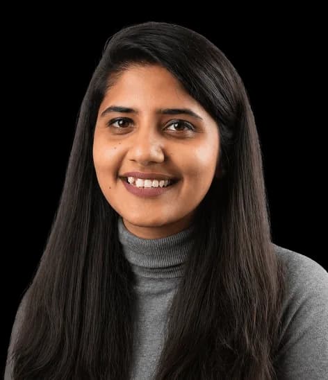 Portrait of a Red Baton team member smiling in a grey turtleneck