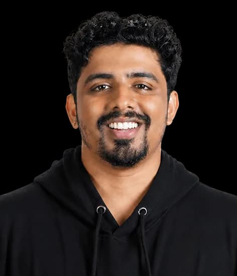 Portrait of a Red Baton team member smiling in a black hoodie