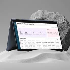 Healthcare admin dashboard showing admission discharge and transfer data on a laptop