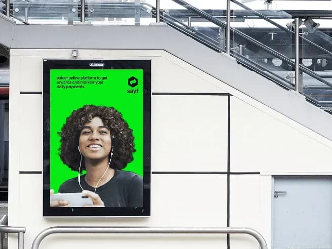 SayF digital payments campaign displayed on a transit advertising screen